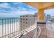 Balcony with table and chairs overlooking white sand beach and ocean at 18610 Gulf Blvd # 607, Indian Shores, FL 33785