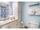Clean bathroom with a vanity, decorative mirror, and coordinated decor at 18610 Gulf Blvd # 607, Indian Shores, FL 33785