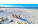 Scenic beach view featuring a wooden bench and a pier in the background at 18610 Gulf Blvd # 607, Indian Shores, FL 33785