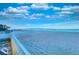 View of beach and ocean from balcony with white railings and view of blue sky with picturesque clouds at 18610 Gulf Blvd # 607, Indian Shores, FL 33785