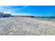 Wide sandy beach with tire tracks and a long pier extending into the calm blue ocean at 18610 Gulf Blvd # 607, Indian Shores, FL 33785