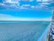 View of beach and ocean from balcony with white railings and view of blue sky with picturesque clouds at 18610 Gulf Blvd # 607, Indian Shores, FL 33785
