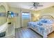 Light and airy bedroom features a ceiling fan and a flat screen television at 18610 Gulf Blvd # 607, Indian Shores, FL 33785
