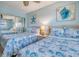 A bedroom with two beds and a full mirrored closet at 18610 Gulf Blvd # 607, Indian Shores, FL 33785