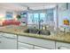 Spacious kitchen with granite countertops, bar seating and open floorplan views at 18610 Gulf Blvd # 607, Indian Shores, FL 33785