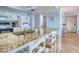 Modern kitchen featuring granite countertops, bar seating, and stainless steel sink at 18610 Gulf Blvd # 607, Indian Shores, FL 33785