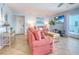 Inviting living room with coral sofas, coastal decor, and sliding doors that open to a balcony at 18610 Gulf Blvd # 607, Indian Shores, FL 33785