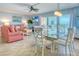 Open-concept living space with a view, dining area, and comfortable seating at 18610 Gulf Blvd # 607, Indian Shores, FL 33785