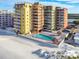 Beautiful beachfront condo complex with a sparkling pool and tiki huts at 18610 Gulf Blvd # 607, Indian Shores, FL 33785