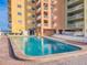Relaxing pool area with a large swimming pool and views of the condo building at 18610 Gulf Blvd # 607, Indian Shores, FL 33785