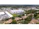 Expansive aerial view of the community with pond, lush trees, and proximity to retail at 1933 Whitney Way, Clearwater, FL 33760