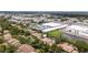 Wide aerial shot showcasing community layout with pond, mature trees, and convenient location at 1933 Whitney Way, Clearwater, FL 33760