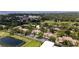 Community aerial highlighting ponds, a pool, and abundant trees at 1933 Whitney Way, Clearwater, FL 33760