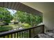 Outdoor balcony with wooded pond views and comfortable seating space at 1933 Whitney Way, Clearwater, FL 33760