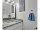Updated bathroom vanity with stone countertop, faucet, and decorative mirror at 1933 Whitney Way, Clearwater, FL 33760