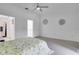 Open bedroom design with light flooring, a ceiling fan and views into an adjacent bathroom at 1933 Whitney Way, Clearwater, FL 33760