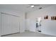 Bedroom with large closet doors, access to the ensuite bath, and bright lighting at 1933 Whitney Way, Clearwater, FL 33760