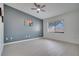 Bedroom with light flooring, neutral paint, ceiling fan and a large window with blinds at 1933 Whitney Way, Clearwater, FL 33760