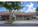 Carport with parking spots and ample storage; lovely landscaping at 1933 Whitney Way, Clearwater, FL 33760