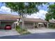 Attached carport provides covered parking, extra storage space, and well-kept landscaping at 1933 Whitney Way, Clearwater, FL 33760
