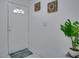A bright entryway featuring a white front door, neutral tile flooring, and simple, stylish decor at 1933 Whitney Way, Clearwater, FL 33760