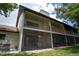 Exterior building elevation showing a rear view, screened in porches, and outdoor space at 1933 Whitney Way, Clearwater, FL 33760