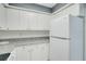 Kitchen with white cabinets, updated appliances, and granite countertops at 1933 Whitney Way, Clearwater, FL 33760