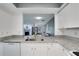 Open concept kitchen with granite countertops and view to living room at 1933 Whitney Way, Clearwater, FL 33760