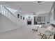 A bright living room with a fireplace, staircase, and sliding glass doors leading to an outdoor area at 1933 Whitney Way, Clearwater, FL 33760