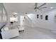 Bright living room with light floors and view to kitchen and stairs at 1933 Whitney Way, Clearwater, FL 33760
