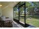Relaxing screened porch with exterior views of a pond, mature trees and manicured lawn at 1933 Whitney Way, Clearwater, FL 33760