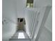 Bright staircase with white railing and view to downstairs fireplace at 1933 Whitney Way, Clearwater, FL 33760