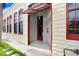 Welcoming exterior entrance featuring textured walls, awning, and red framed windows at 2001 E 2Nd Ave # 37, Tampa, FL 33605