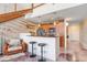 Modern kitchen open to the living room with hardwood stairs and bar top seating at 2001 E 2Nd Ave # 37, Tampa, FL 33605