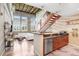 Modern kitchen open to the living room with hardwood stairs and exposed ceiling at 2001 E 2Nd Ave # 37, Tampa, FL 33605