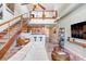 Lofted living room features concrete walls, sleek white sofas, stairs to loft, and modern décor at 2001 E 2Nd Ave # 37, Tampa, FL 33605