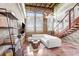 Living room features a white sofa, hardwood stairs, exposed brick and wood ceiling at 2001 E 2Nd Ave # 37, Tampa, FL 33605