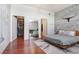 Modern main bedroom featuring a platform bed, brick wall, large mirror, and closet at 2001 E 2Nd Ave # 37, Tampa, FL 33605