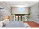 Modern main bedroom featuring an exposed brick wall, platform bed, and loft view at 2001 E 2Nd Ave # 37, Tampa, FL 33605