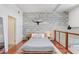 Modern bedroom features concrete walls, wood floors and loft railing at 2001 E 2Nd Ave # 37, Tampa, FL 33605