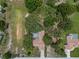 Aerial view of home with screened in pool in a lush, wooded area at 204 Oak Lake Dr, Spring Hill, FL 34608