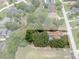 Aerial view of home with screened in pool in a lush, wooded area, outlined with property lines at 204 Oak Lake Dr, Spring Hill, FL 34608