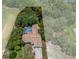 Aerial view of home with screened in pool in a lush, wooded area, outlined with property lines at 204 Oak Lake Dr, Spring Hill, FL 34608