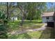 Well-maintained backyard with lush greenery, mature trees, and a charming brick pathway at 204 Oak Lake Dr, Spring Hill, FL 34608
