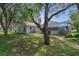 Lovely backyard view showcasing mature trees and the screened-in pool area at 204 Oak Lake Dr, Spring Hill, FL 34608