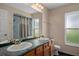 Bathroom features double sink vanity, toilet and tub/shower combination with a window for natural light at 204 Oak Lake Dr, Spring Hill, FL 34608