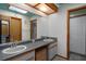 Well-lit bathroom featuring double sinks, ample counter space, and wooden cabinetry at 204 Oak Lake Dr, Spring Hill, FL 34608