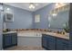 A fully renovated bathroom featuring an oversized garden tub and matching dual sink vanities at 204 Oak Lake Dr, Spring Hill, FL 34608