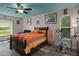 Comfortable bedroom featuring unique ceiling color, modern decor, and exercise bike at 204 Oak Lake Dr, Spring Hill, FL 34608