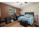 Bedroom with hardwood-style floors, window, and black storage chest at 204 Oak Lake Dr, Spring Hill, FL 34608